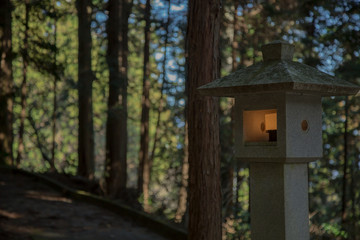 Traditional Japanese lantern with light in the forest