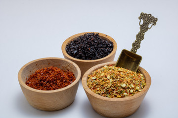 various spices in wooden bowls isolated on white background