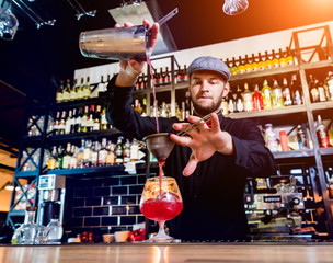 Bartender is making cocktail at bar counter. Fresh cocktails. Barman 