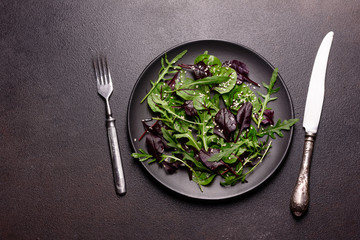 Healthy food, salad mix with arugula, spinach, bulls blood, beet leafs and micro greens