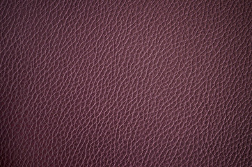 Leather texture close up. Deep purple fashionable background, top view. Stylish violet wallpaper with rough surface.