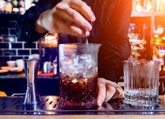 Bartender is making cocktail at bar counter. Fresh cocktails. Barman 