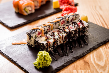 Sushi roll Green Dragon with avocado, ell, wasabi and ginger. Restaurant.