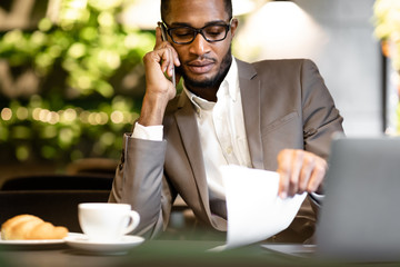 Portrait of black manager talking on mobile phone