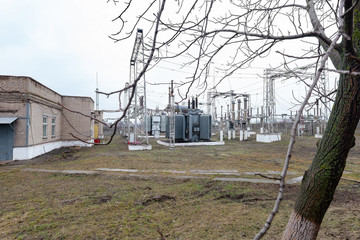 High voltage urban electrical substation with high voltage wires and transformers.