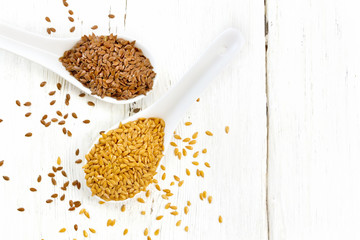 Flaxen white and brown in two spoons on wooden board top