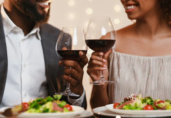 Man and woman looking at each other and toasting, cropped