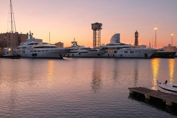 Luxury boats moored in the port. View of the harbor in the evening.