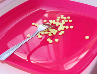 the pills are on a red plate with a fork