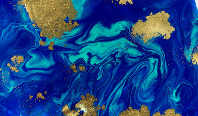 Obraz na płótnie Canvas Marbled blue and gold abstract background. Liquid marble pattern.