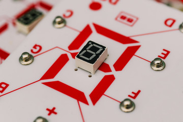 Chip with a digital LED indicator. Seven-segment indicator. Electronic constructor. Display device for digital information. The study of physics and electrical engineering.