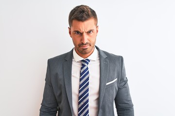 Young handsome business man wearing suit and tie over isolated background skeptic and nervous, frowning upset because of problem. Negative person.