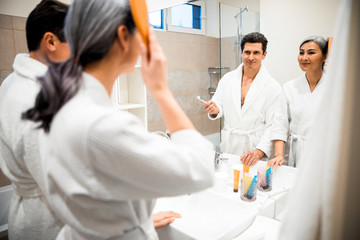 Fototapeta premium Happy adult couple is standing in bathroom