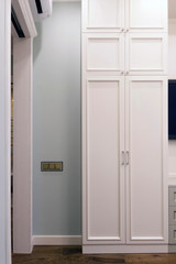 White wardrobe in an apartment with a Scandinavian interior design
