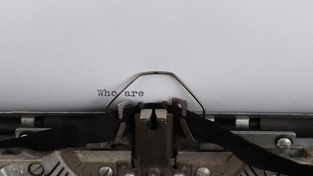 typing question who are you, old vintage typewriter with a sheet of paper