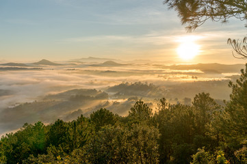 nice day in Da Lat, on the top of mountain view down of city in fog, sun light and rays