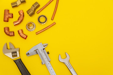 Set of tools for plumbing isolated on yellow background with space for advertising