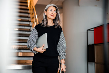 Beautiful smiling boss with modern laptop stock photo