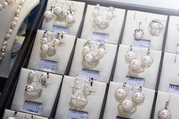  retail gold store showcase displaying  luxury pearls  jewerly