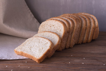 sliced white bread lies on a wooden table