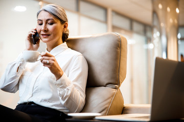 Looking at the cup of coffee while talking stock photo