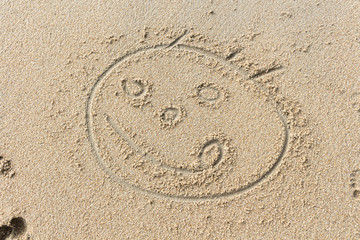 Smiling face on the sand