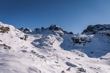 Beautiful alpine panoramic view snow capped mountains, European beautiful winter mountains.