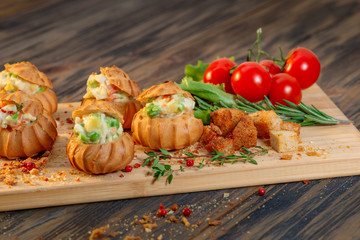 Profiteroles with vegetable filling, tomatoes and herbs