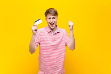 young blonde man with a credit card