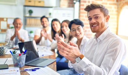 Group of business workers smiling happy and confident. Working together with smile on face looking at the camera applauding at the office