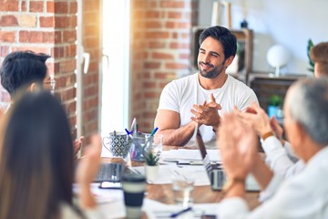 Group of business workers smiling happy and confident. Working together with smile on face applauding one of them at the office