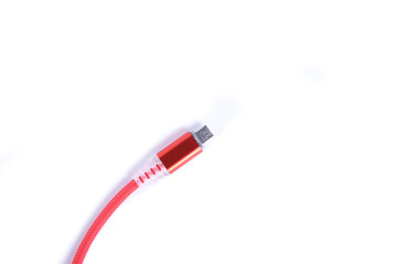 Red USB cable for smartphone charge isolated on white background.