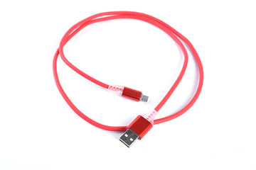 Red USB cable for smartphone charge isolated on white background.