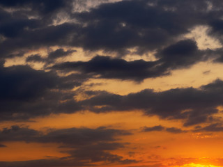 Dark gray clouds on a red sunset sky