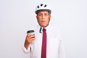 Senior businessman wearing bike helmet drinking coffee over isolated white background with a confident expression on smart face thinking serious