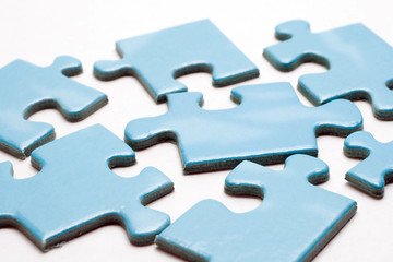 Blue puzzle pieces on white background