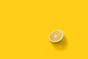 sliced  green lemon lime on a yellow background