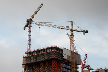 Building on construction site with cranes