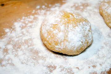 Fototapeta na wymiar Fresh raw dough on a wood pastry board