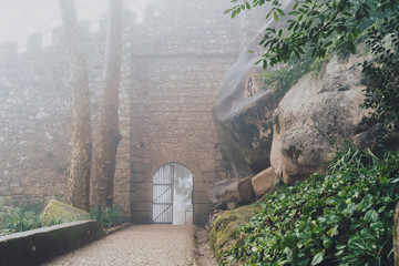 Gated entrance to the Moorish Castle in Sintra Portugal on a foggy misty day
