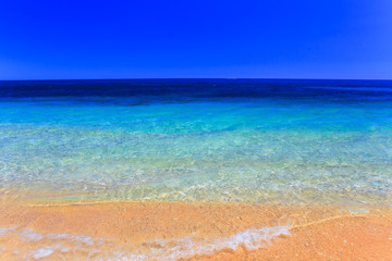 Fototapeta na wymiar Beautiful sea summer or spring abstract background. Golden sand beach with blue ocean