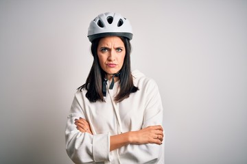 Young cyclist woman with blue eyes wearing bike helmet over isolated white background skeptic and nervous, disapproving expression on face with crossed arms. Negative person.