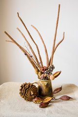 Autumn brown dry plants bouquet (still life) on light background. View from above