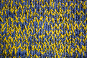 Blue and ywllow knitted (knitting) woolen fabric texture with craft words on it and window for text in the center
