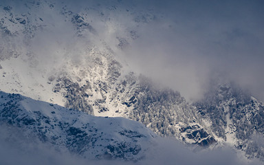 Light play in the snow dusted mountains