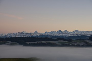 World famous mountain range of Eiger Monch and Jungfrau in sunset glow