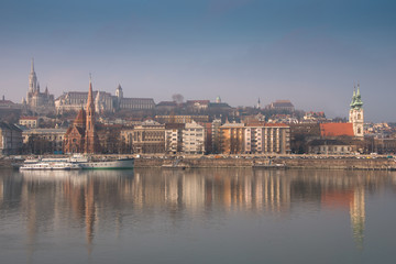 Fototapeta na wymiar Panoramic scape of the old town Budapest. View on Fisherman's Bastion, Matthias Church, Reformed Church and Danube river on the foreground. Hungary. Top tourist attraction in Europe. 
