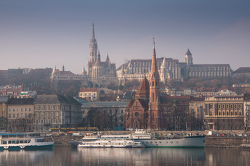 Fototapeta na wymiar Panoramic scape of the old town Budapest. View on Fisherman's Bastion, Matthias Church, Reformed Church and Danube river on the foreground. Hungary. Top tourist attraction in Europe. 