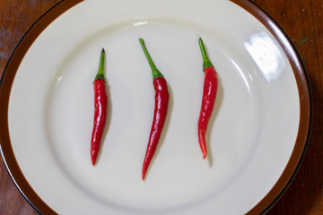 Three chilies arranged on a plate