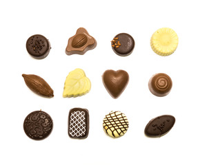 Studio shot chocolate pralines display in three rows decoration isolated on white top view